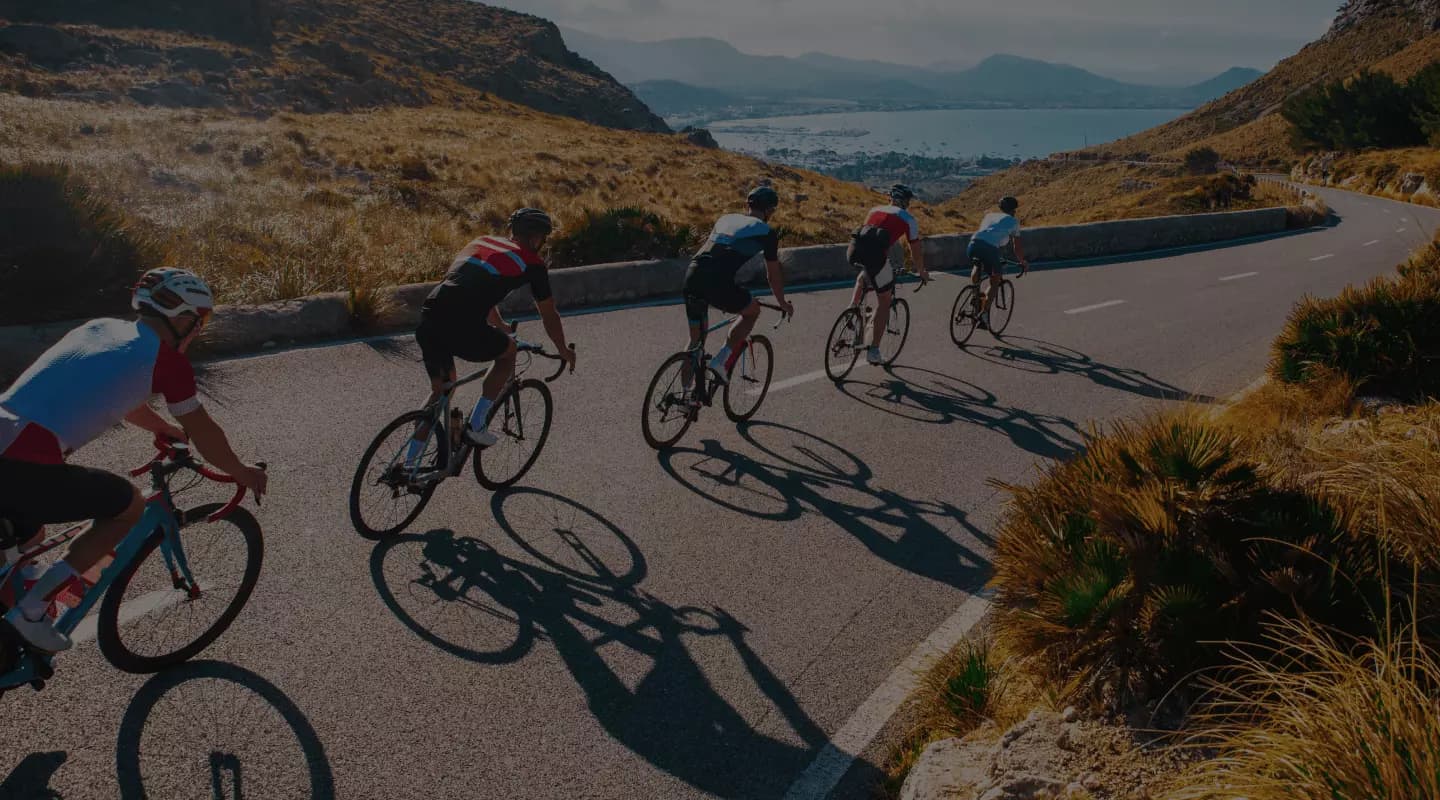 Cyclists riding a coastal mountain road in Europe